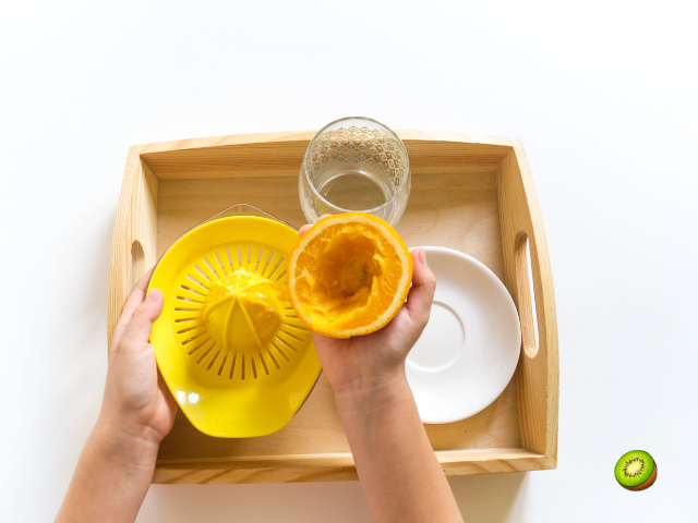 a kid making orange juice